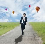 Businessman Running On Road Stock Photo