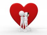 Couple Embracing Against A Big Red Heart Stock Photo