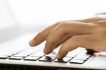 Closeup Hand Typing On Laptop Keyboard Stock Photo