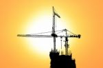 Sunset And Silhouette Construction With Crane On Top Building Stock Photo