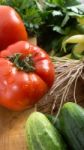 Several Vegetables On Wooden Chopping Board And Table Stock Photo