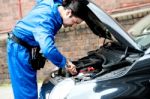 Young Male Mechanic Fixing Car Engine Stock Photo