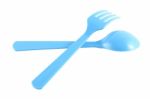 Cross Blue Plastic Spoon And Fork On White Background Stock Photo