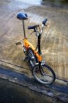 Folding Bicycle On Wet Road Stock Photo