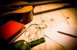 Guitar With Red Book And Wine On A Wooden Table Stock Photo