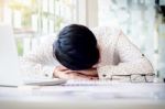 Tired Businessman Sleeping While Calculating Expenses At Desk I Stock Photo