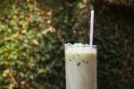 Matcha Tea With Milk On Garden Table Stock Photo