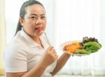 Fat Woman Eating Salad Stock Photo