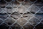 Fence And Grunge Wall Stock Photo