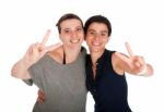 Sisters Showing Victory Sign Stock Photo