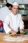 Male Chefs Actively Working In Kitchen Stock Photo