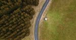 Road And Field In The Tasmanian Countryside Stock Photo