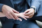 Wedding Ring Put On The Bride's Finger Stock Photo