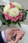 Groom Hands Hold The Keys And Hand The Bride With A Bouquet Of Bride Stock Photo