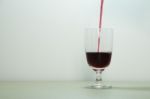 Pouring Red Wine In Glass Stock Photo