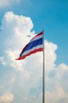 Thailand Flag Against Clouds And Blue Sky Stock Photo