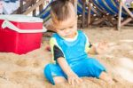 Asian Boy Playing Sand On The Beach Stock Photo