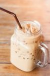 Glass Of Iced Coffee On Wooden Table With Vintage Filter Style Stock Photo