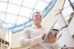 Businessman With Tablet Computer In Modern Building Stock Photo