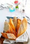 Sliced Baguette With Kitchenware Stock Photo