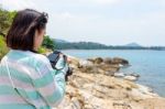 Young Woman Photography Near The Sea Stock Photo