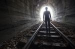 Man In A Tunnel Looking Towards The Light Stock Photo