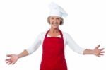 Happy Aged Chef Gesturing Welcome Stock Photo