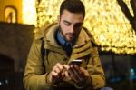 Portrait Of Young Man Using His Mobile Phone On The Street At Ni Stock Photo