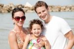 Family Of Three On The Beach Stock Photo