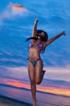 Beautiful Black African American Woman Jumping On The Beach At S Stock Photo