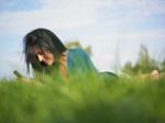 Young Woman Using Laptop In Park Stock Photo