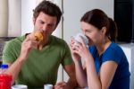 Couple Having Tea And Snacks Stock Photo