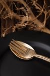 Black Empty Plate Fork Spoon On Wooden Table Background Stock Photo