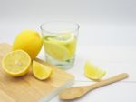 Fresh Lemon In Water And Lemon Slice On White Wood Background Stock Photo