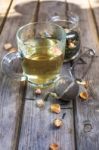 Mug Of Flavored Green Tea With Rose Buds And Petals Stock Photo