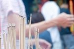 Incense Stick Burning Slowly With Fragrant Smell Smoke. People Praying On Chinese Buddhist Temple On Chinese New Year, Luna New Year Stock Photo