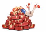 Woman's Legs Sticking Out From A Pile Of Gifts Stock Photo