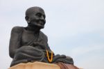 Giant Black Monk Statue In Thailand Temple Stock Photo