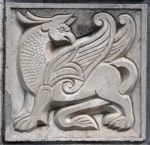 Old Bas-relief Of Fairytale Winged Lion Stock Photo