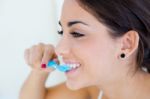 Pretty Young Woman Brushing Her Teeth Stock Photo