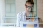 Young Beautiful Woman Reading Newspaper At Home Stock Photo