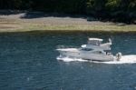 A Motorboat Rapidly Crossing The Straits Between Victoria (vanco Stock Photo