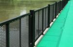 Green Walkway With Metal Fence By The Lake Stock Photo