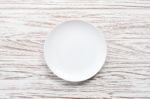 Empty Plate On White Wooden Table Background  Flat Lay Stock Photo