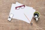 Blank Paper With Pencil A Cup Of Coffee Mobile Phone And Eye Glasses Stock Photo