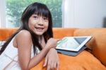 Girl Playing With Tablet Stock Photo