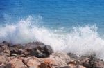 Wave Crash Against With Rock Beach Stock Photo