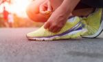 Closeup Hand Tying Laces Ready For Run On Road At Sunset Stock Photo