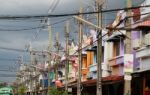 Row Of Colorful Houses With Power Pole And Messy Cable In Thailand Stock Photo