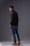 Casual Young Man In Black Leather Jacket And Denim Jeans Stock Photo